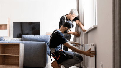 Maintenance workers fixing heater