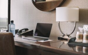 laptop on top of a hotel room table