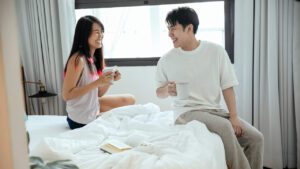 guest experience_couple sitting on a bed