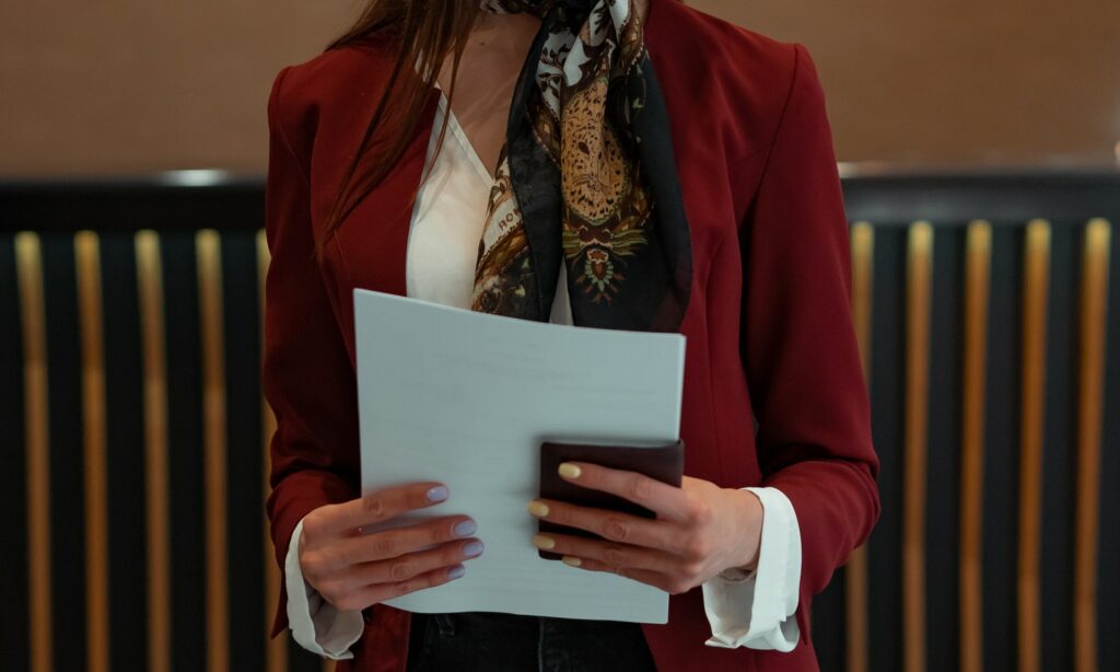 Front desk worker at hotel holding a passport