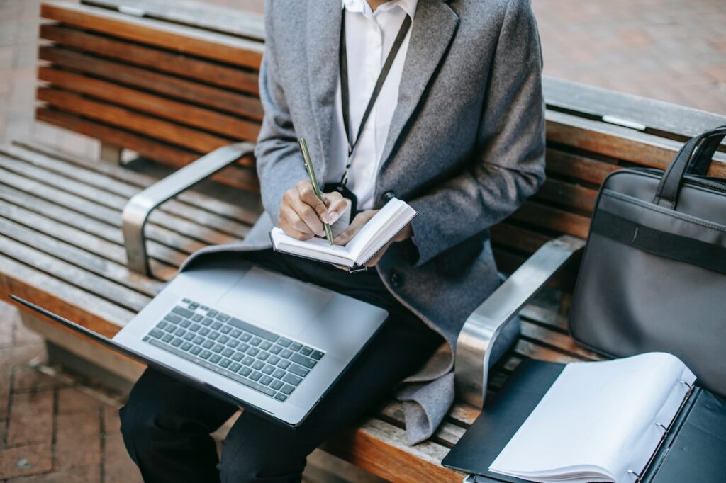 Person with laptop on lap using a notebook