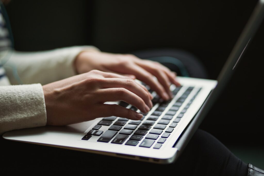 Someone typing on a computer