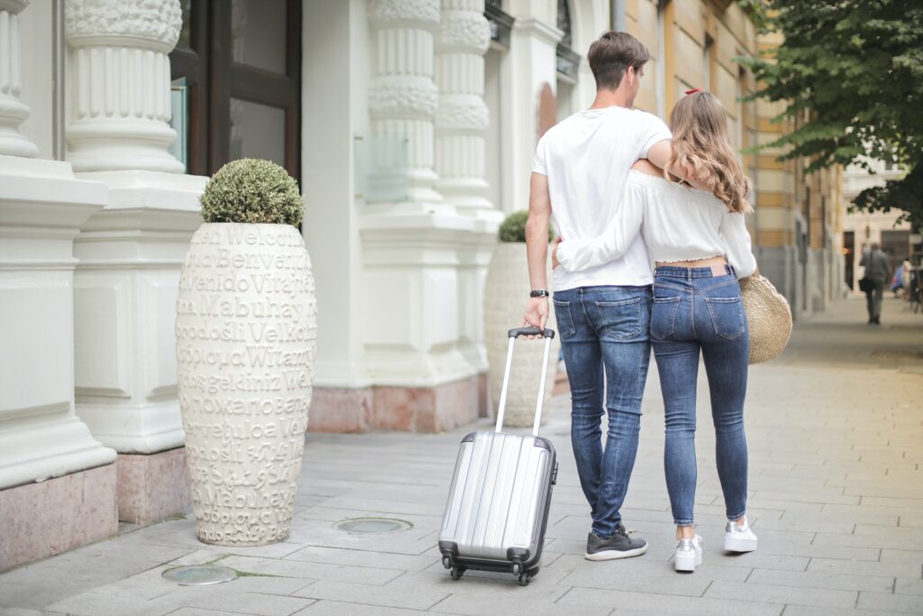A photo of a couple on vacation with a suitcase to show listing differentiation