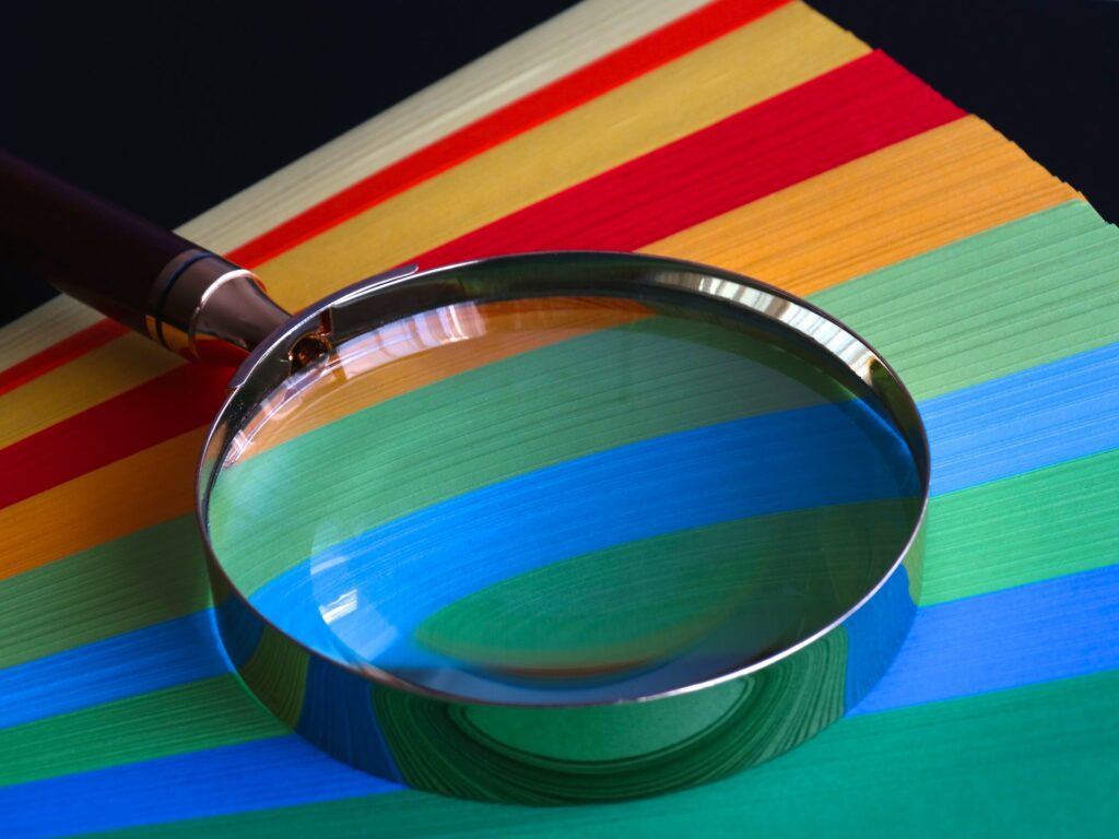 A photo of a magnifying glass on a colorful table