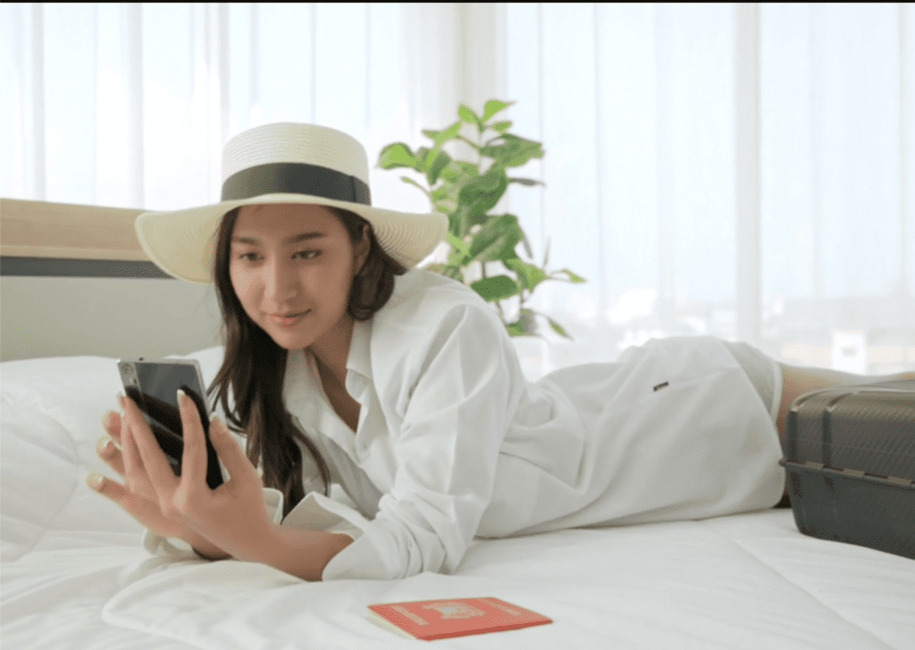 Tourist on a bed looking at a phone