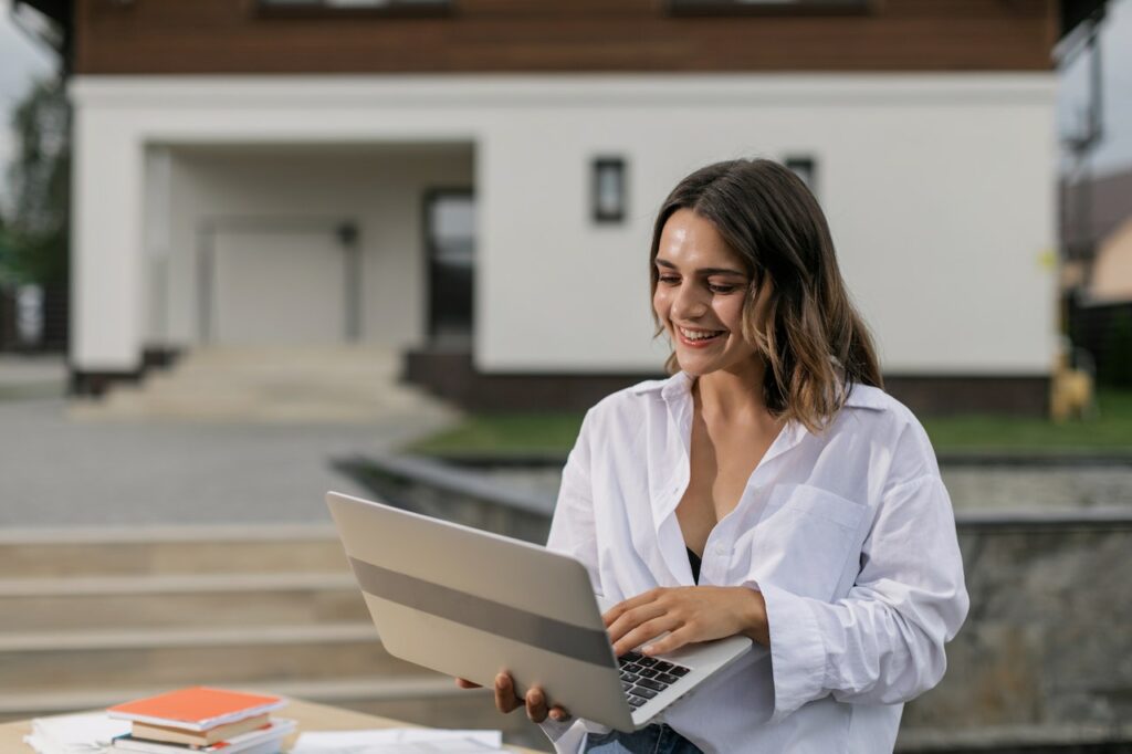 Woman smiling using a laptop