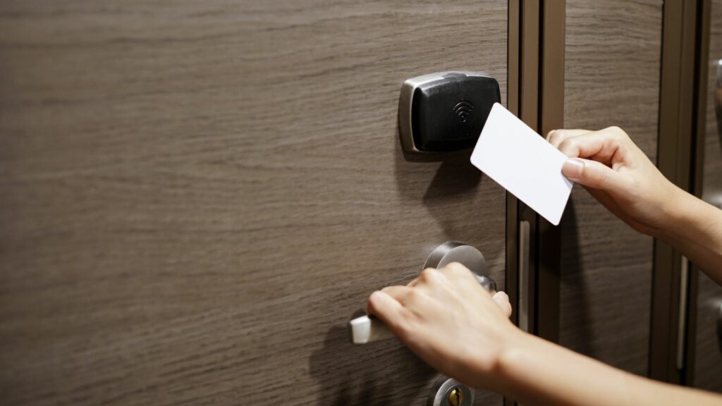 person opening a hotel door with a keycard