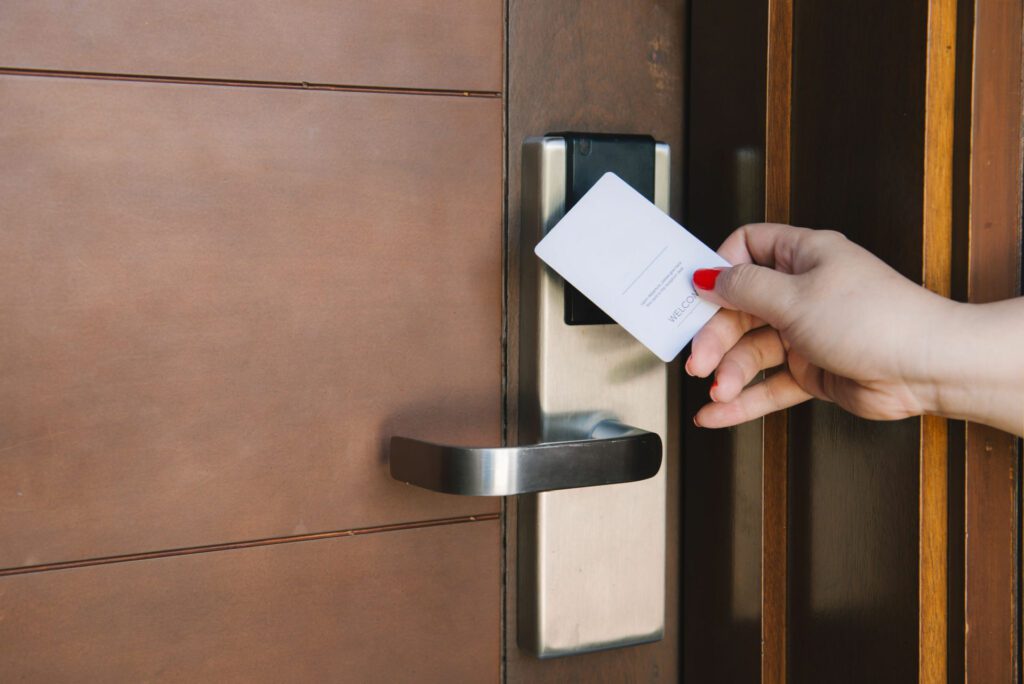 Person scanning a keycard on a hotel door