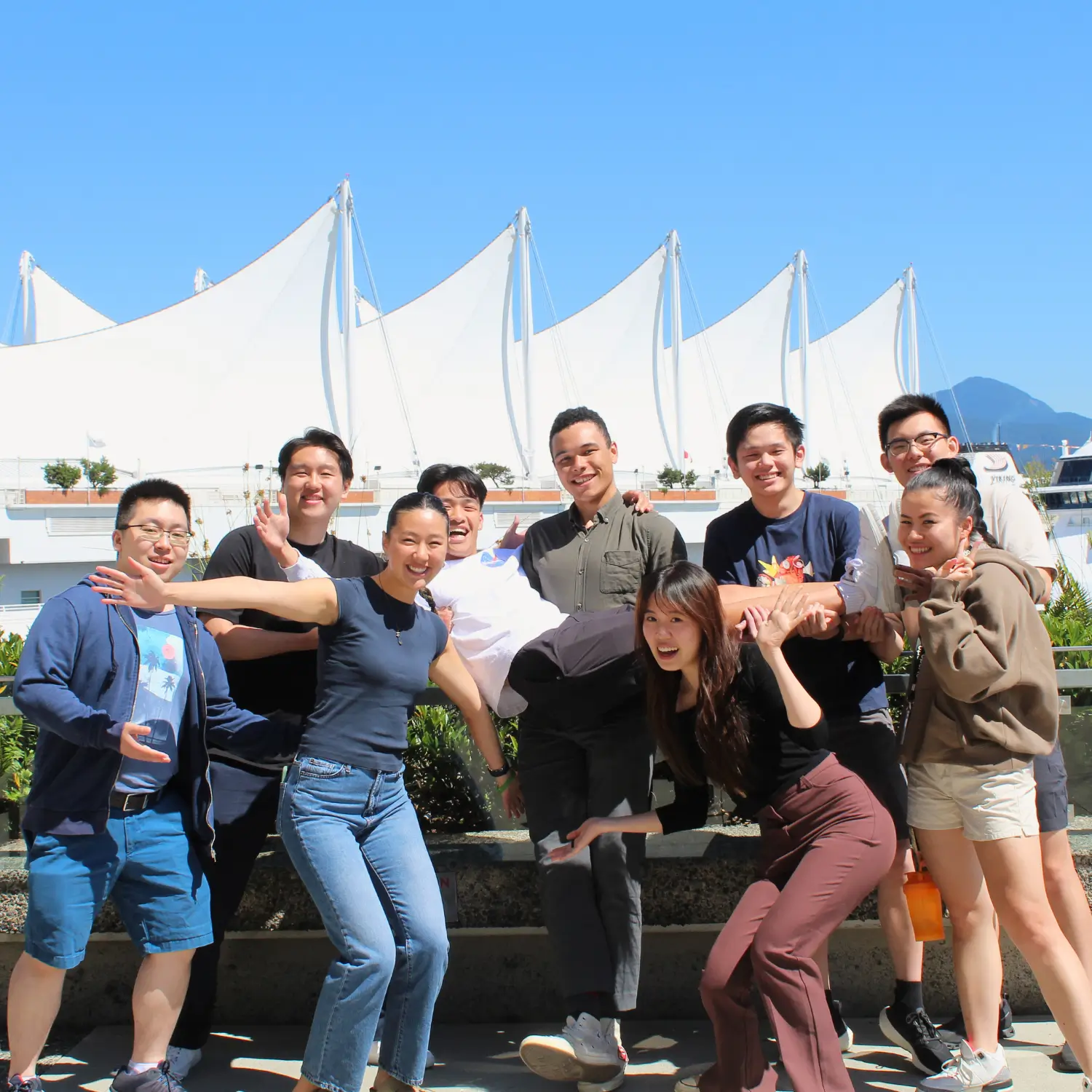 Smiling Co-op employees pose in front of Canada Place