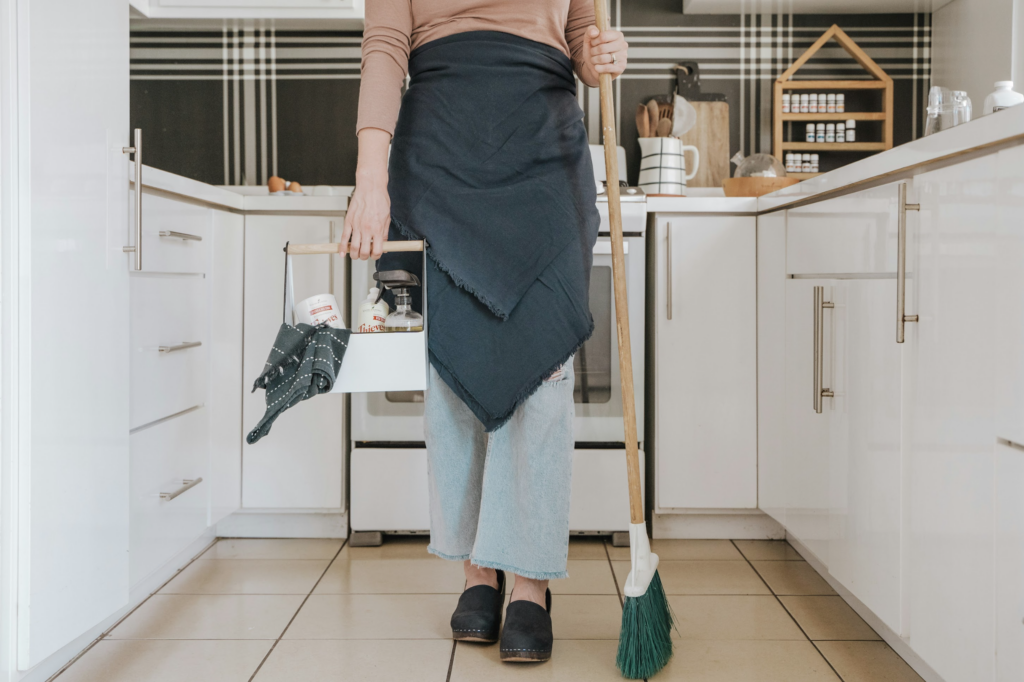 Woman holding cleaning supplies