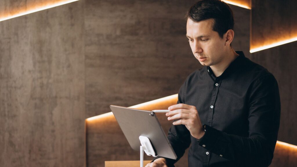 Hotel staff using a tablet to automate guest registration in Europe.